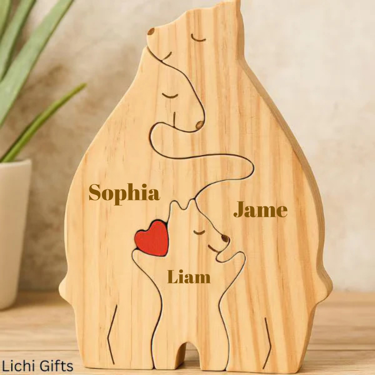 Wooden sculpture of two bears with a heart and names engraved, on a neutral background.