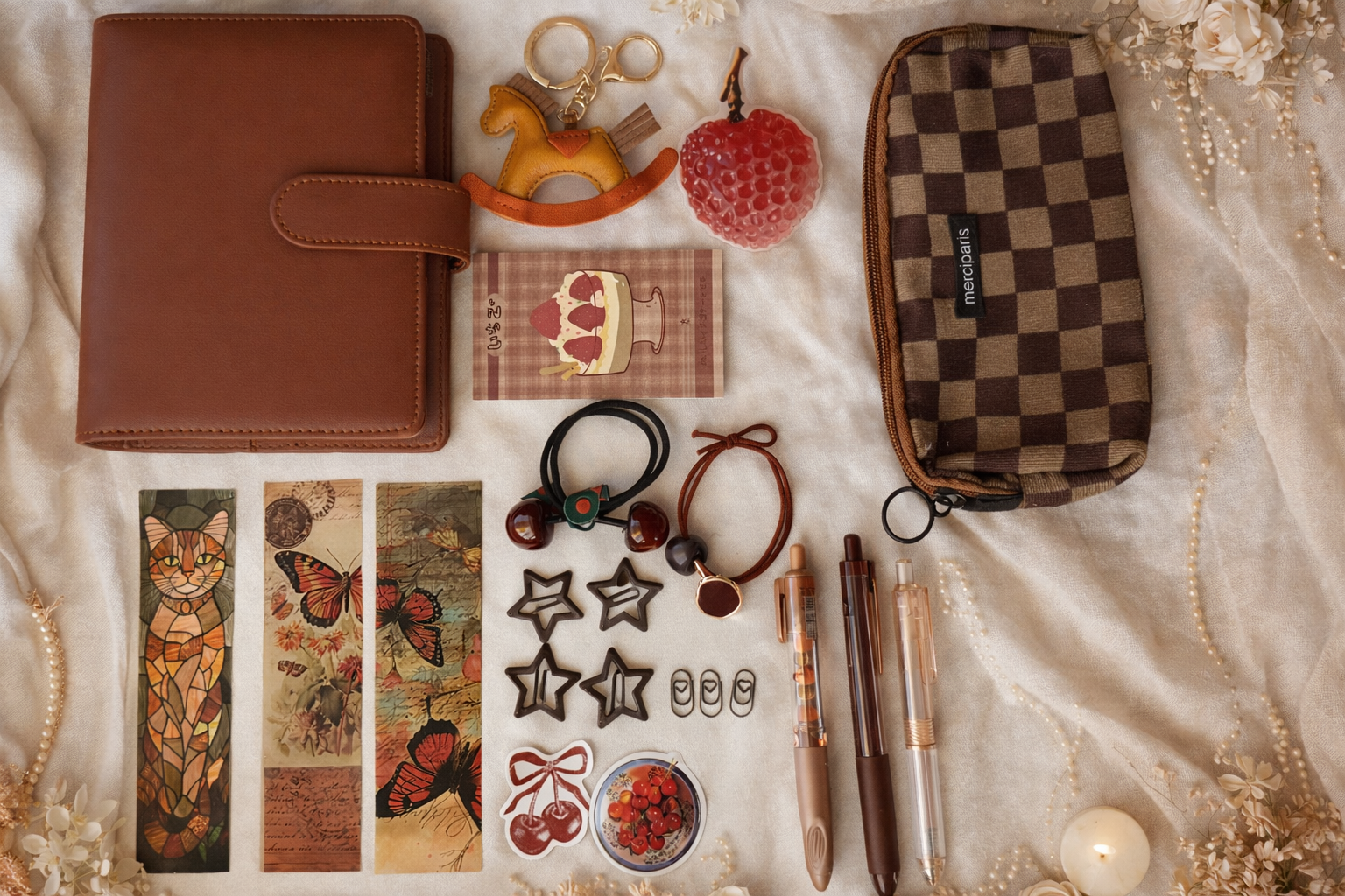 Collection of small items including a brown leather wallet, checkered pouch, and decorative objects on a textured surface.